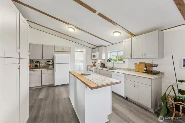 View of kitchen, new flooring, paint, cabinets, trim, great storage.
