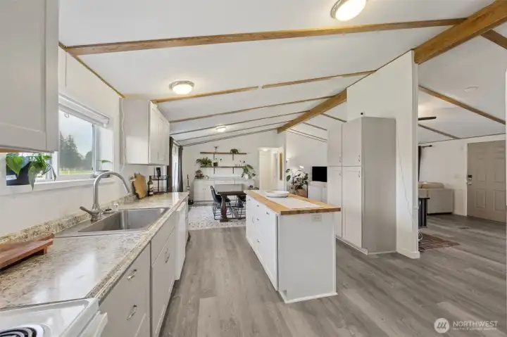 Another view of the kitchen towards dining area.  New flooring, cabinets, paint, countertop.