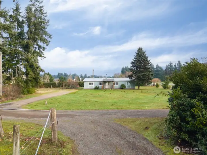 View of home from midpoint of property.  Well maintained.  Some fencing.  Not fully fenced.