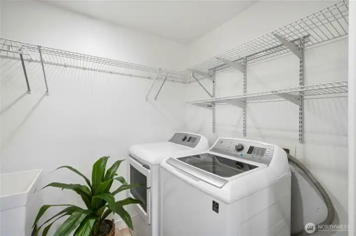 The utility room has a large laundry tub and lots of shelving for extra storage.