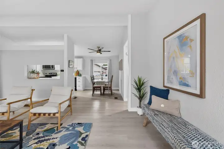 Open-concept living, dining, and kitchen—made for connection. The pass-through window keeps movie nights easy, with popcorn and drinks always within reach