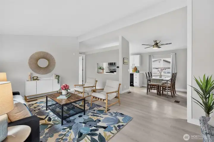 Vaulted ceilings and natural light create a bright, airy feel, while the primary suite just off the living room welcomes the morning sun through its north & south-facing windows.