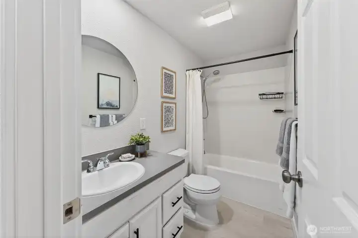 Bright and well-appointed, the full bathroom offers comfort and convenience for the additional bedrooms.