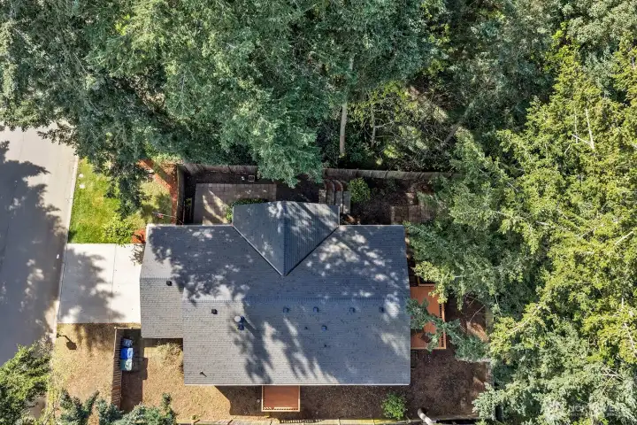 Aerial view of the home and the fenced lot. A piece of privacy and serenity and still close to all amenities.