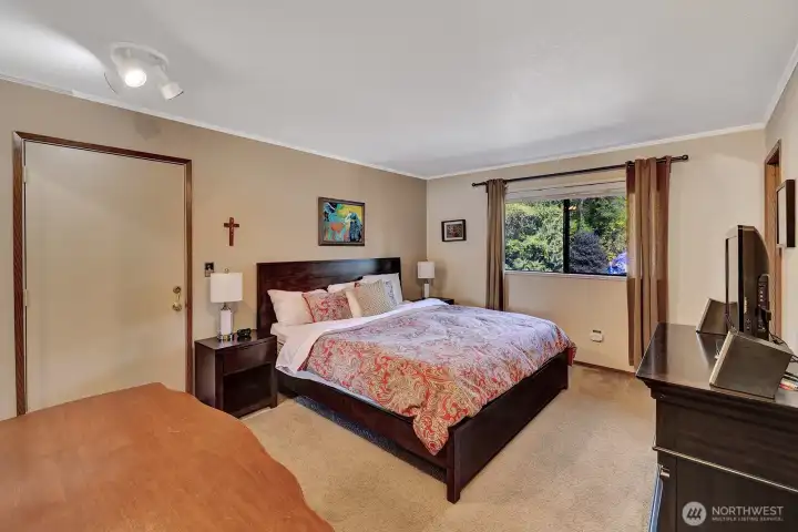 Primary bedroom has an access door to the back deck area. Sit out there and read a book, enjoy nature at its best