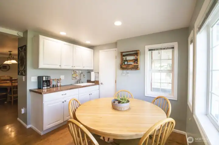 Cozy breakfast nook with adjacent coffee bar and easy access to the kitchen