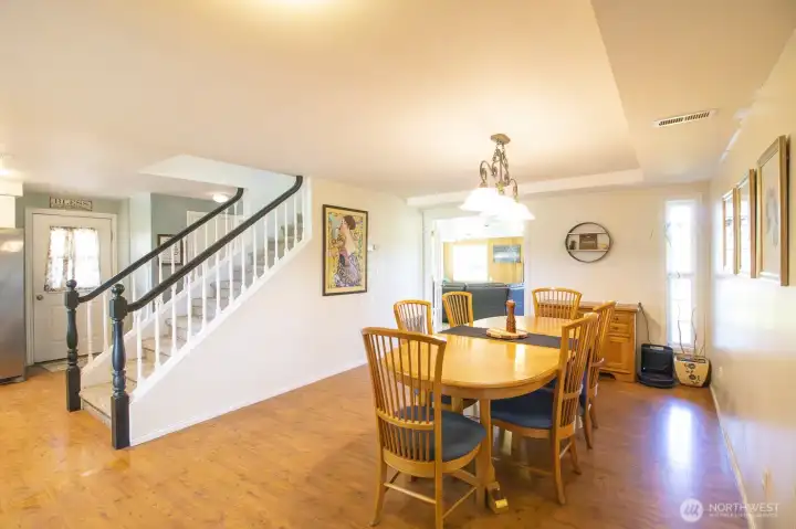 Open dining space featuring warm wood flooring