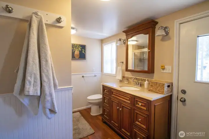 Spacious master bathroom featuring a walk-in shower w/ dual shower heads and direct access to private deck