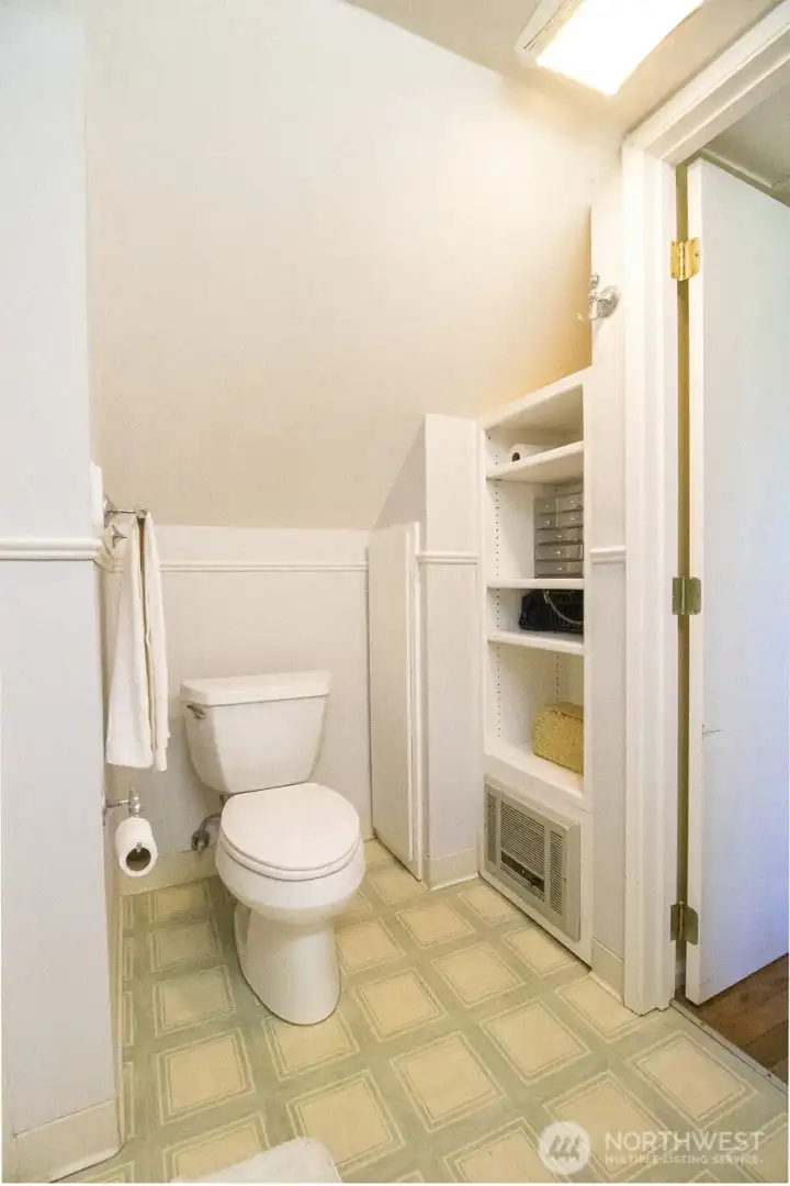 Convenient upper-level full bathroom with built-in shelving/storage