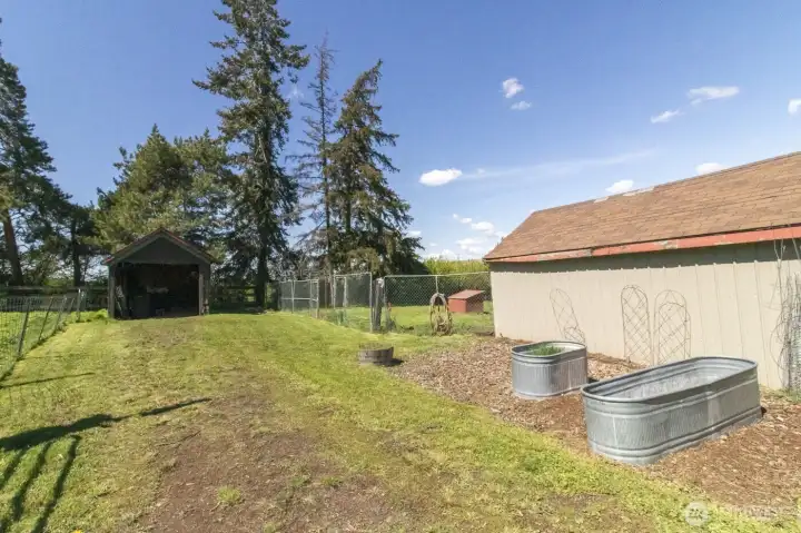 Exterior view of storage sheds and garden space