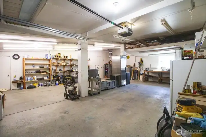 Spacious bay 1 & 2 with concrete floors and room for equipment, storage, or workshop use.