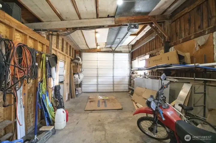 Shop bay with 10' door and versatile workspace/storage potential.