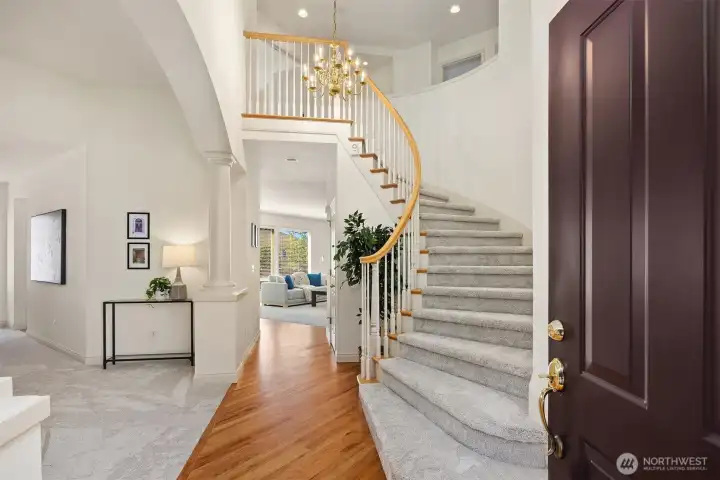 Step into the grand entry with vaulted ceilings and gleaming, refinished hardwood floors.