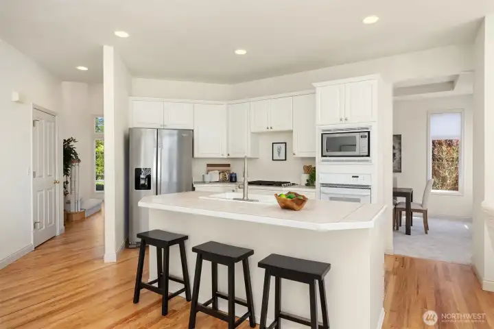 The kitchen truly serves as the heart of the home with access to the formal dining room while opening to the spacious family room.