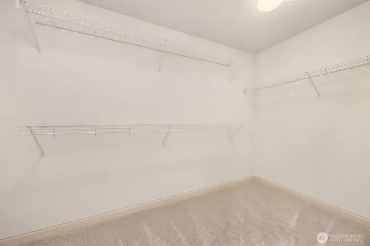 Expansive walk-in closet designed to keep everything organized and within easy reach.