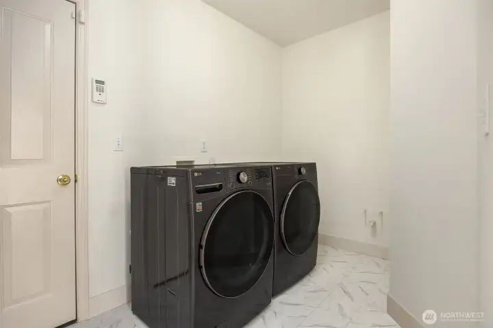Convenient utility room offers easy access to the 3-car garage and features a newer washer and dryer.