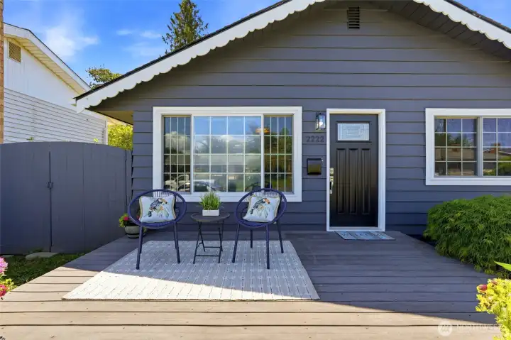 A large front deck adds both style and functional outdoor living space.
