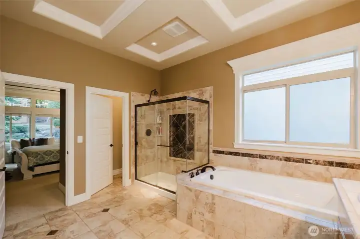 Spa-inspired and generously sized, the primary bath features a soaking tub, oversized walk-in shower, and timeless tile finishes.
