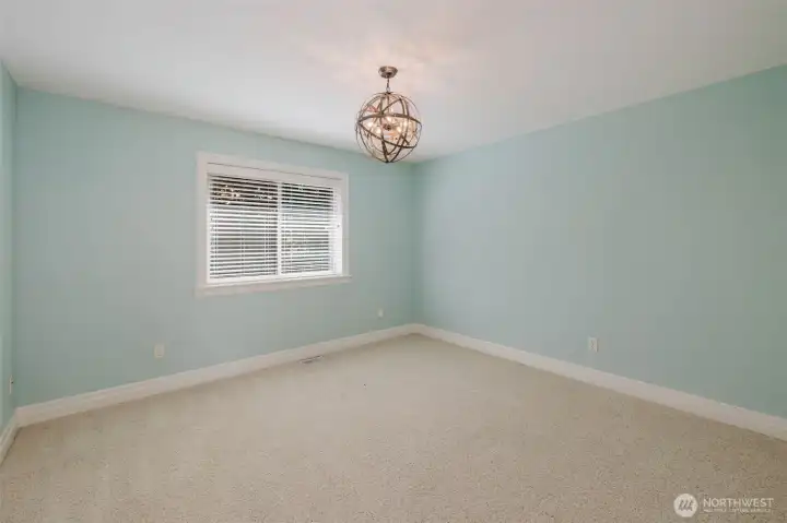Bright and inviting, this spacious bedroom features soft natural light, generous closet space, and room to personalize for family, guests, or hobbies.