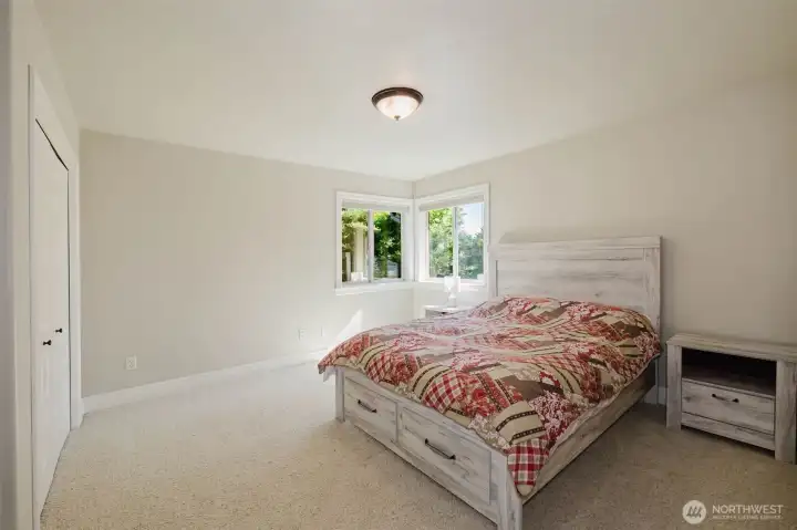 Filled with natural light, this comfortable bedroom provides a welcoming retreat for guests, family members, or a dedicated workspace.