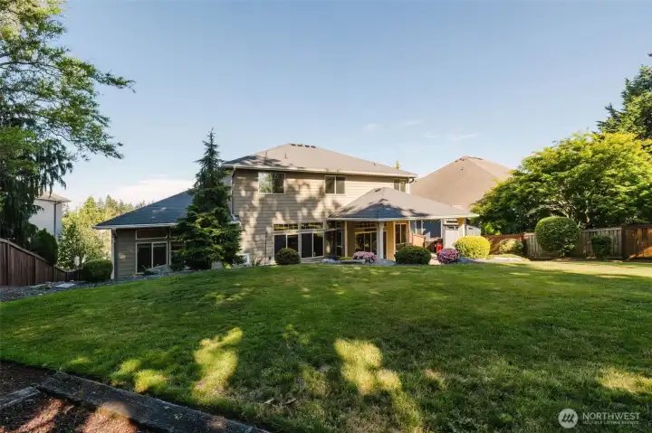 Surrounded by mature trees and established landscaping, the backyard combines privacy, beauty, and functional outdoor space.