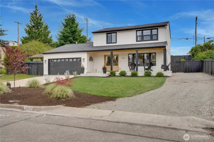 Board and batten exterior with painted brick, black window frames, Japanese maple, and designer landscaping — the curb appeal is immediate and unmistakable. Board and batten exterior with painted brick, black window frames, Japanese maple, and designer landscaping — the curb appeal is immediate and unmistakable.