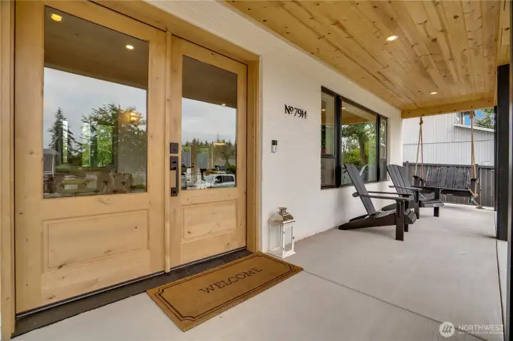 Knotty alder double entry doors under a cedar tongue-and-groove porch ceiling with recessed lighting — the kind of front porch you actually use. Knotty alder double entry doors under a cedar tongue-and-groove porch ceiling with recessed lighting — the kind of front porch you actually use.