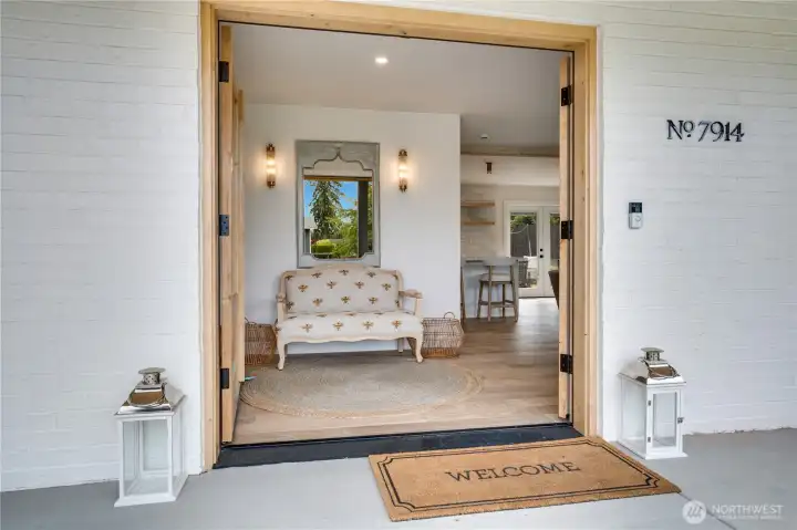 Step inside through oversized knotty alder double doors — engineered hardwood floors, soaring ceilings, and natural light greet you immediately. Step inside through oversized knotty alder double doors — engineered hardwood floors, soaring ceilings, and natural light greet you immediately.