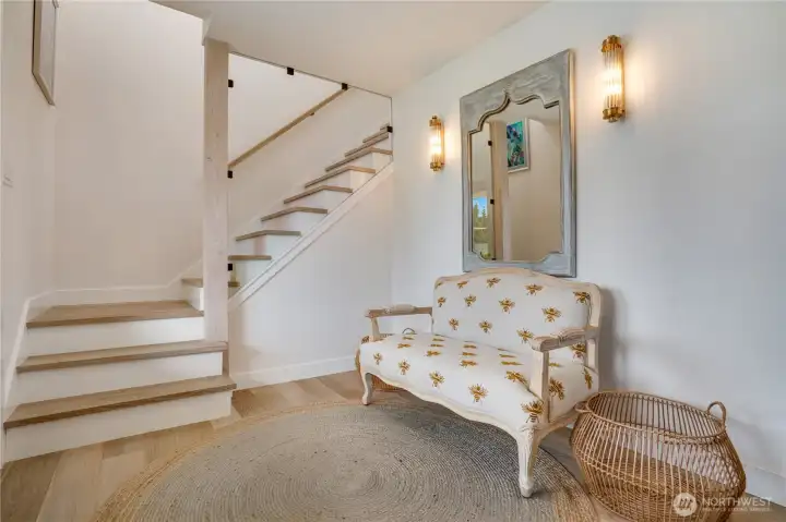 Whitewashed oak stair treads, frameless glass railing panels, and brass wall sconces — custom details that punch well above the price point. Whitewashed oak stair treads, frameless glass railing panels, and brass wall sconces — custom details that punch well above the price point.