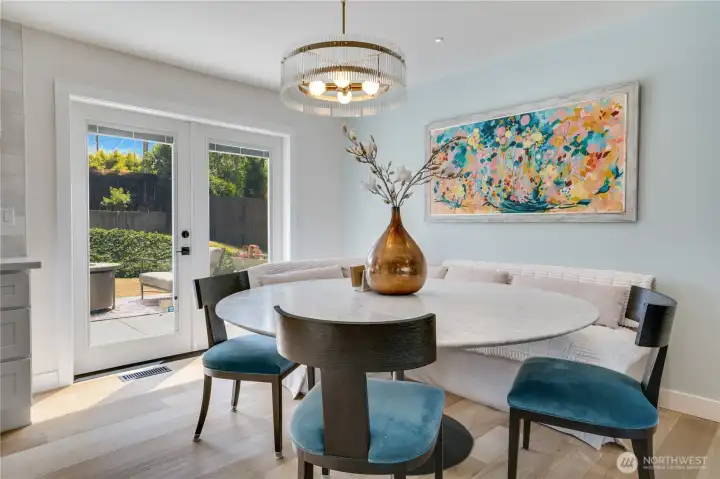 French doors from the dining nook connect interior to exterior in one effortless transition — morning coffee inside or out, your choice French doors from the dining nook connect interior to exterior in one effortless transition — morning coffee inside or out, your choice