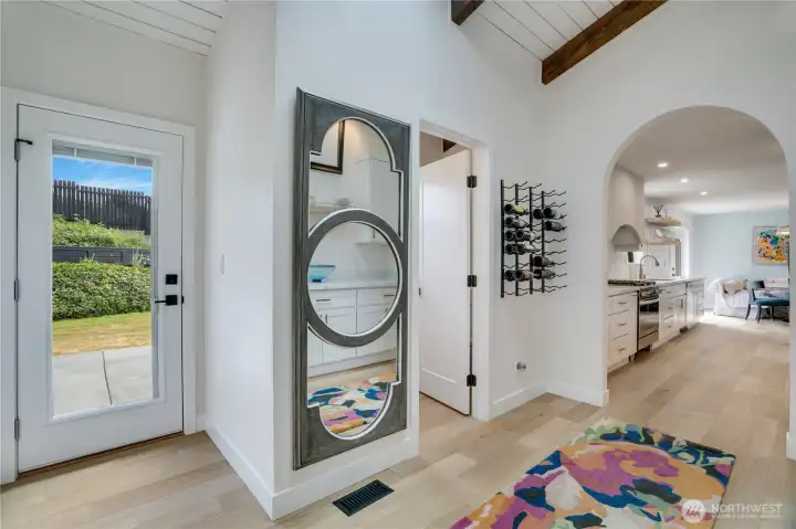 The main floor unfolds in every direction — soaring shiplap ceiling with exposed beam, built-in wine rack, half bath access, butler’s pantry entry, and the kitchen framed through a graceful arch. This home has a place for everything. The main floor unfolds in every direction — soaring shiplap ceiling with exposed beam, built-in wine rack, half bath access, butler’s pantry entry, and the kitchen framed through a graceful arch. This home has a place for everything.