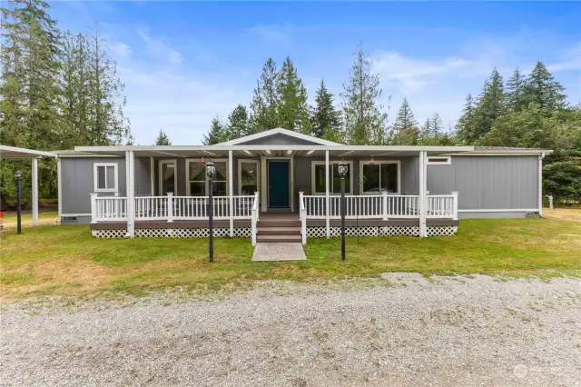 The charming main home with expansive covered porch welcomes you