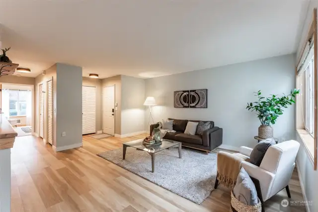 Living room is spacious and an open floor plan to dining room and kitchen.  Hallway down to the bedrooms to the left.