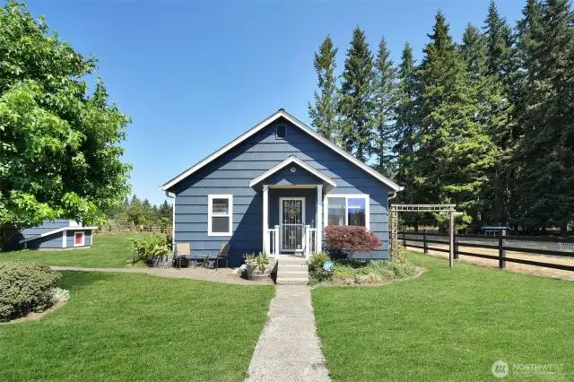 Front of home, 40 year roof installed 2011, fresh paint 2018, garage and wellhouse to the left, grass has been retouched