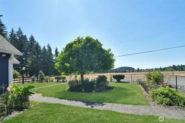 South facing view between home and garage of beautiful flower lanscaping and mountain/territorial view