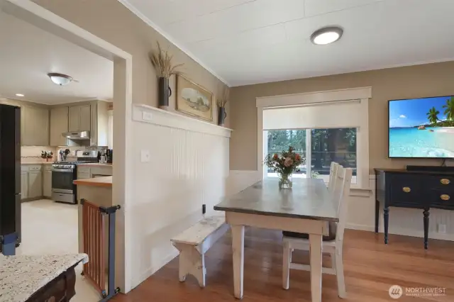 Dining area off living room, kitchen entrance on left