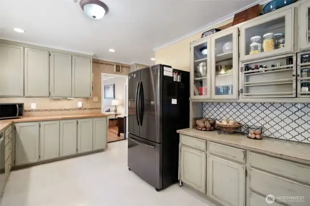 Kitchen with butcher block counters, spice rack cabinet, stainless steel appliances less than 3 years old