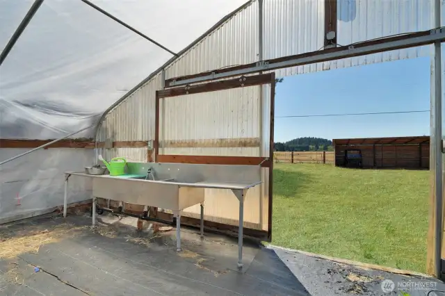 South facing front entrance of greenhouse, wash basin and vegetable prep area, plumbed and drains to septic, grass has been retouched
