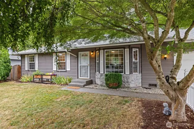 Sidewalk up entry and mature landscaping.