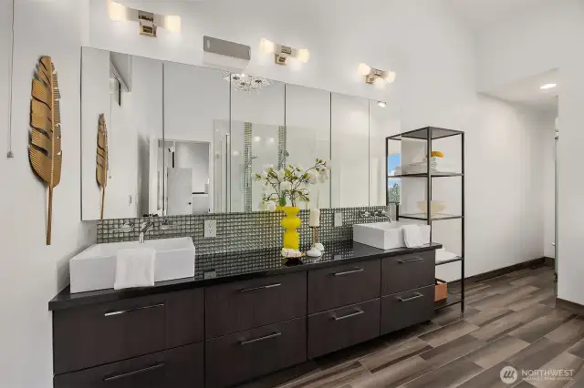 The updated bathroom with double sinks has heated floors and modern finishes throughout.