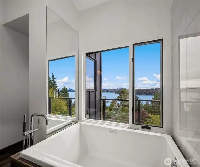 Cleverly designed, the bathroom features a mirror above the tub that perfectly reflects the stunning Seattle skyline—a truly unique touch!
