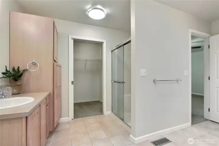 Primary ensuite bath view two showing shower, 2nd vanity and walk-in closet.
