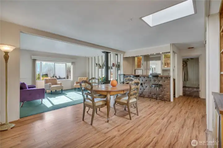 Open living & dining room with bar has new carpet & new laminate floors ~