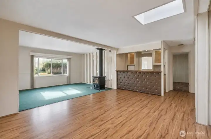 Open living & dining room with bar has new carpet & new laminate floors ~
