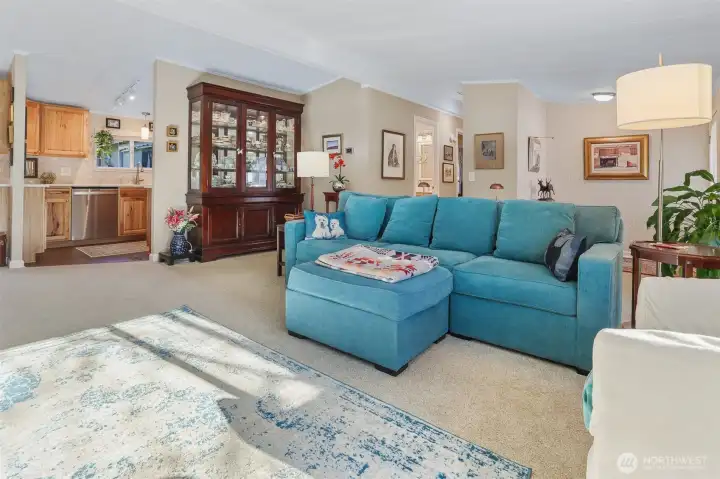 Formal living room with vaulted ceilings, sliding door to front patio and picture window overlooking the community greenbelt and trail