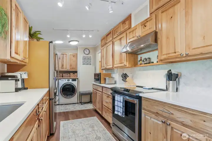 Remodeled kitchen features Hickory cabinets, quartz counters, LVP floors, GE cafe stainless appliances and an eating bar to the dining room.