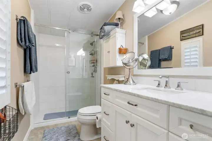 Master bedroom suite overlooks the community pond and greenbelt.  Double closets, vaulted ceilings and a remodeled full bathroom with a walk in shower