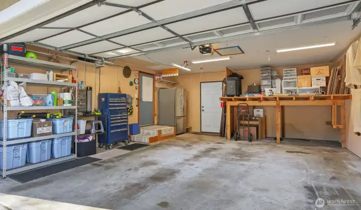 2 car attached garage and level driveway with additional 2 uncovered parking spaces