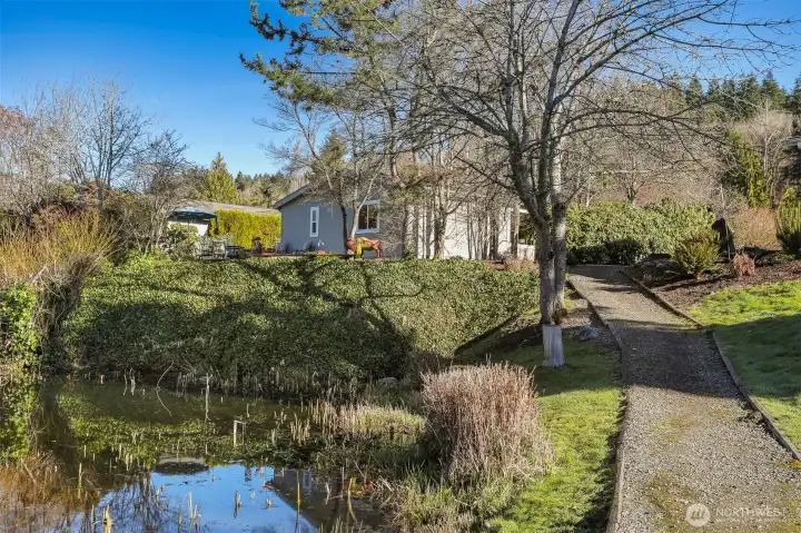 View of the back yard and house from the Community greenbelt and trail overlooking the pond