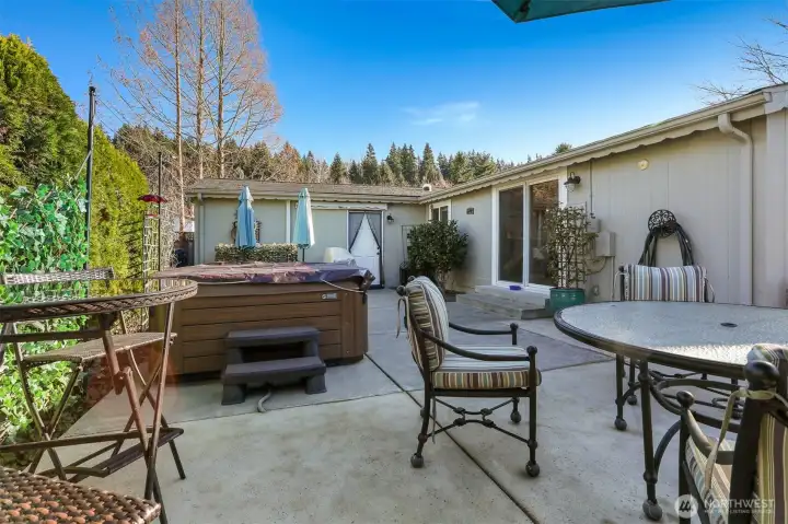 Private back patio with western exposure, turf lawn and overlooks the community pond-